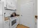 Kitchen featuring granite countertops, white cabinets, and modern appliances for easy meal preparation at 800 S Dakota Ave # 337, Tampa, FL 33606