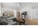 Comfortable living room with hardwood floors, gray sofa, television, and dining area view at 800 S Dakota Ave # 337, Tampa, FL 33606