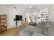 Open living space featuring a comfortable sofa, hardwood floors, and a kitchen bar counter at 800 S Dakota Ave # 337, Tampa, FL 33606