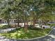 Serene park view with lush greenery, mature trees, a water fountain, and walkways at 800 S Dakota Ave # 337, Tampa, FL 33606