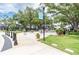 Park area featuring lush grass, shade trees, outdoor seating, and paved walkways at 800 S Dakota Ave # 337, Tampa, FL 33606