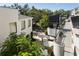 Outdoor patio with tables, umbrellas, and green space at 800 S Dakota Ave # 337, Tampa, FL 33606