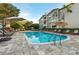 Community pool with lounge chairs, umbrellas and beautiful landscaping at 800 S Dakota Ave # 337, Tampa, FL 33606