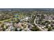 This aerial shows the property nestled near lush greenery and a beautiful golf course at 8060 Canterbury Cir, Seminole, FL 33777