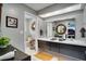 A stylish bathroom featuring a dual sink vanity, large mirrors, and an adjacent toilet room at 8060 Canterbury Cir, Seminole, FL 33777