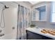 This bathroom features a shower/tub combo, and a bright vanity with sink and mirror at 8060 Canterbury Cir, Seminole, FL 33777