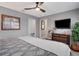 This bedroom has an ensuite and a flatscreen TV, with views out to the patio at 8060 Canterbury Cir, Seminole, FL 33777