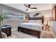 Comfortable bedroom featuring a ceiling fan, a large bed and a bright window with views of the outside at 8060 Canterbury Cir, Seminole, FL 33777