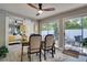 A dining room featuring a sliding door out to the patio and an opening through to the Primary Bedroom at 8060 Canterbury Cir, Seminole, FL 33777