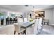 Bright dining area features a long table with seating for eight and modern light fixture at 8060 Canterbury Cir, Seminole, FL 33777