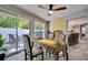 A dining room and office space featuring a bright sliding door to the outside, with a view of the kitchen at 8060 Canterbury Cir, Seminole, FL 33777