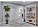 Bright entryway featuring decorative rugs, plants, and a statement bookcase, offering a warm welcome at 8060 Canterbury Cir, Seminole, FL 33777