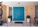 Close-up of a vibrant double front door flanked by planters, creating an inviting entrance at 8060 Canterbury Cir, Seminole, FL 33777