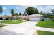 Charming single-story home with well-manicured lawn, mature landscaping, and a two-car garage at 8060 Canterbury Cir, Seminole, FL 33777