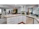 Spacious kitchen with white cabinetry, stainless steel dishwasher, and an open layout at 8060 Canterbury Cir, Seminole, FL 33777