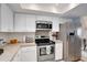 Modern kitchen with stainless steel appliances, ample cabinet space, and clean countertops at 8060 Canterbury Cir, Seminole, FL 33777