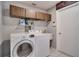 Laundry room with modern washer and dryer and a Game Room sign at 8060 Canterbury Cir, Seminole, FL 33777