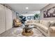 Expansive living room featuring comfortable seating, a unique coffee table, and an open floor plan at 8060 Canterbury Cir, Seminole, FL 33777
