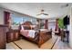 Comfortable main bedroom featuring a wooden bed frame, bedside tables, and natural light at 8060 Canterbury Cir, Seminole, FL 33777