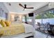 Primary bedroom featuring a large sliding glass door, ceiling fan, bright window, and white dresser at 8060 Canterbury Cir, Seminole, FL 33777