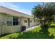 Home's backyard featuring a well-kept lawn, a mature tree, and a patio for outdoor enjoyment at 9314 Alta Sol Way, New Port Richey, FL 34655
