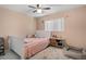 Cozy bedroom with ceiling fan, plush rug and view of window. Featuring a bed and bedside table at 9314 Alta Sol Way, New Port Richey, FL 34655