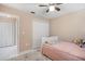 Comfortable bedroom with a ceiling fan, closet, and plush rug, bathed in natural light at 9314 Alta Sol Way, New Port Richey, FL 34655
