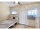 Simple bedroom featuring a built in bookshelf, concrete floors, and a white door at 9314 Alta Sol Way, New Port Richey, FL 34655