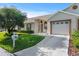 Inviting single-story home features a well-manicured lawn and attached garage under a clear blue sky at 9314 Alta Sol Way, New Port Richey, FL 34655