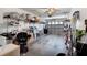 A large garage is filled with storage shelves and various items, offering ample space at 9314 Alta Sol Way, New Port Richey, FL 34655