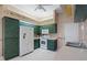 Vintage kitchen boasts white appliances, tile flooring, and unique countertops at 9314 Alta Sol Way, New Port Richey, FL 34655