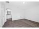 Clean bedroom with neutral carpeting and entry to the bathroom at 9471 Eldridge Rd, Spring Hill, FL 34608