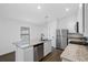 Bright kitchen featuring stainless steel appliances, granite countertops, and an island with a sink at 9471 Eldridge Rd, Spring Hill, FL 34608