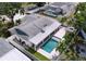 Aerial shot of a home with pool, outdoor kitchen, patio, manicured landscaping and fenced yard at 9580 130Th Ave, Largo, FL 33773