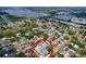 Neighborhood aerial view of home with pool surrounded by lush landscaping near lake at 9580 130Th Ave, Largo, FL 33773