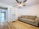 Living room with hardwood floors, a large bookcase, and neutral color sofa at 9580 130Th Ave, Largo, FL 33773
