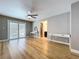 A bedroom featuring hard wood floors, a ceiling fan, and sliding glass doors to the outside at 9580 130Th Ave, Largo, FL 33773
