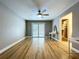 Bedroom featuring hardwood floors, ceiling fan, sliding glass doors, and closet with custom shelving at 9580 130Th Ave, Largo, FL 33773