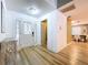 Bright foyer with wood floors, a decorative front door, and a view into the dining area at 9580 130Th Ave, Largo, FL 33773