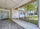 Charming front porch with a decorative glass door, tiled floor, and inviting curb appeal at 9580 130Th Ave, Largo, FL 33773