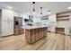 Bright, modern kitchen with stainless steel appliances, white cabinets, and a large island at 9580 130Th Ave, Largo, FL 33773