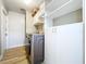 Laundry room featuring modern washer and dryer, shiplap accent wall, and custom built-in shelving at 9580 130Th Ave, Largo, FL 33773