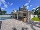 Covered patio and seating areas with pool views offers space for relaxing and outdoor gatherings at 9580 130Th Ave, Largo, FL 33773