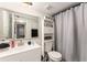 Tastefully updated bathroom with modern vanity, neutral-toned decor, and shower with curtain at 9700 Starkey Rd # 312, Seminole, FL 33777