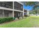 Attractive condo exterior featuring screened lanais, lush landscaping, and a well-maintained lawn at 9700 Starkey Rd # 312, Seminole, FL 33777