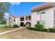 Charming condo featuring well-maintained landscaping, a red tile roof, and inviting archway at 9700 Starkey Rd # 312, Seminole, FL 33777