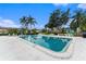 Community pool surrounded by lounge chairs and lush trees at 9700 Starkey Rd # 312, Seminole, FL 33777