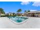 Community pool with chairs and tables plus surrounding trees and landscaping at 9700 Starkey Rd # 312, Seminole, FL 33777