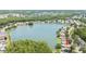 Aerial view of a home with a lake view, surrounded by lush greenery and a neighborhood at 9721 Fredericksburg Rd, Tampa, FL 33635