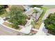 Aerial shot of home with long driveway, mature trees, lush yard, and palm trees on a sunny day at 9721 Fredericksburg Rd, Tampa, FL 33635
